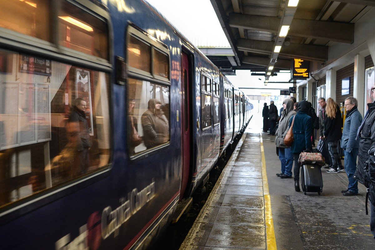 Commuters getting on a train at a platform