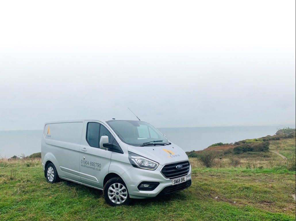 Hcomm van on a cliff overlooking the sea