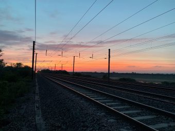 Railway tracks with the sky red and the Sun set